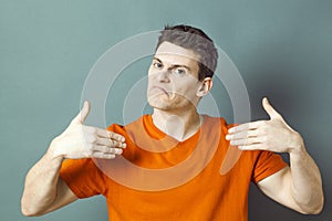 Disappointed man showing himself with hands for low self-esteem