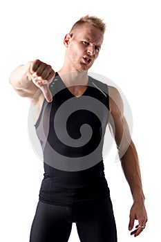 Disappointed muscular young man doing thumb down sign