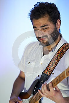 Disappointed musician of his music playing guitar in studio