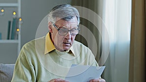 Disappointed sad upset shocked caucasian elderly male get official bank notification rejection read bad news in letter