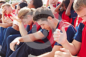 Disappointed Spectators In Team Colors Watching Sports Event photo