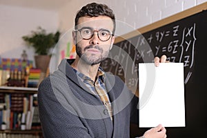 Disappointed teacher holding test with bad results