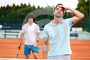 Disappointed tennis player playing tennis on court