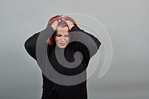 Disappointed woman in despair holding her hair with hands in a bad mood