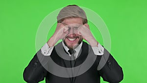 Disappointed Young Businessman Reacting Loss on Green Background