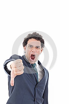 Disappointed young businessman showing thumb down sign