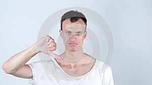 Disappointed young man with thumb down