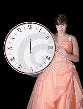 Disappointed young woman in gown & midnight clock