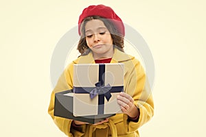 Disappointing purchase. Child stylish hold open gift box. Girl cute little lady coat and beret throws out gift. Spring