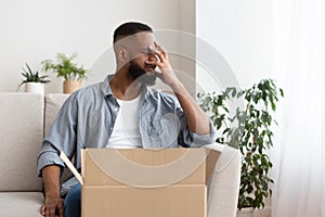 Disappointment in online shopping concept. Guy presses hand to face