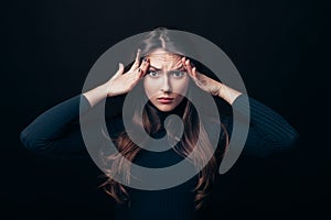 Disappointment stressed woman touching head isolated on black background