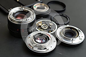 Disassembled camera lenses on black background