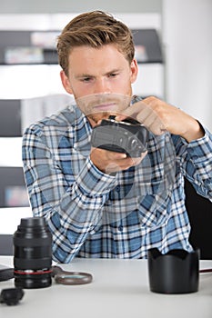 Disassembled camera and photographer working