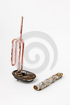 Disassembled clean heating element for heating water in domestic water heaters and boilers on a white background. Copy space.