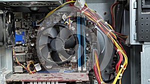 Disassembled dusty system unit. Man's hand scrolls a fan