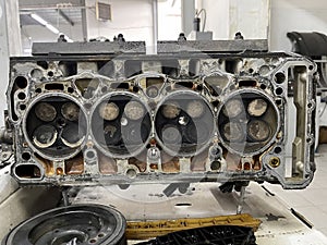 Disassembled engine with heavy dirt and soot on the valves