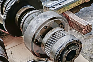 Disassembled gear wheels of a metalworking machine being repaired in a workshop