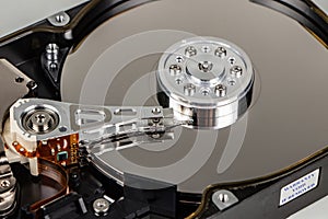 Disassembled hard drive from the computer, hdd with mirror effect. Opened hard drive from the computer hdd with mirror effects.