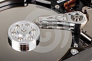 Disassembled hard drive from the computer, hdd with mirror effect. Opened hard drive from the computer hdd with mirror effects.