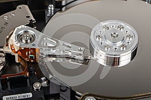 Disassembled hard drive from the computer, hdd with mirror effect. Opened hard drive from the computer hdd with mirror effects.