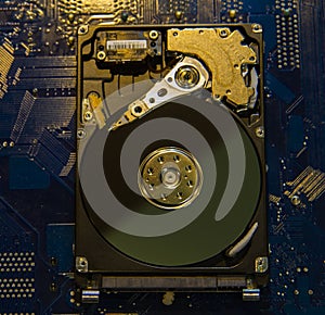 Disassembled hard drive from a laptop. hdd on motherboard