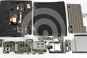 Disassembled laptop, notebook components, monitor, keyboard, motherboard, hard disk drive, CD ROM drive