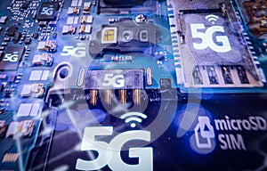 Disassembled mobile phone or smartphone without a back cover, and 5G or LTE word printed in circuit board. Macro shot.