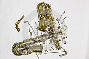 Disassembled saxophone with details and pads.