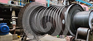 Disassembled steam turbine in the process of repairing and electric generator at power plant