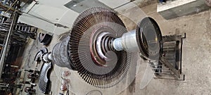 Disassembled steam turbine in the process of repairing and electric generator at power plant