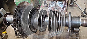 Disassembled steam turbine in the process of repairing and electric generator at power plant