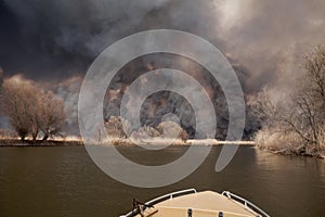 Disaster. Large fire in Astrakhan region. Russia. Black dense smoke and ash from burning reeds rises high into sky and pollutes