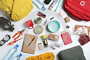 Disaster supply kit for earthquake on white wooden table, flat lay