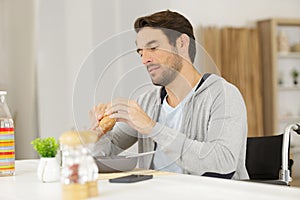 disbaled man having breakfast at home