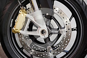 Disc brake with wheel hub on motorbike. Close up of front disc brake on motorcycle. Motorcycle car care and maintenance concepts