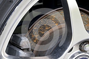 Disc brakes of cars that have rust stains attached.