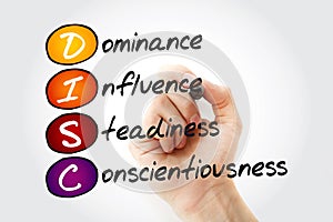 DISC Dominance, Influence, Steadiness, Conscientiousness acronym with marker, personal assessment tool to improve work photo