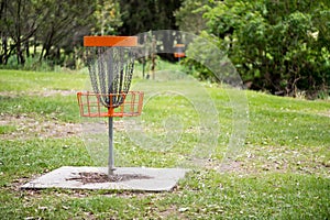 Disc golf basket in a park