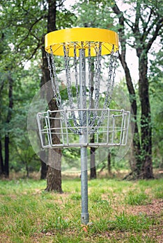 Disc golf target basket in wooded park