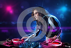 Disc jockey playing music with electro light effects and lights