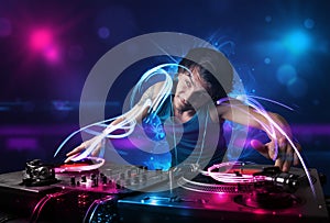 Disc jockey playing music with electro light effects and lights