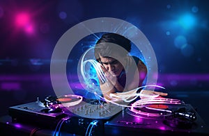 Disc jockey playing music with electro light effects and lights