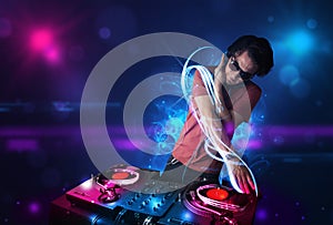 Disc jockey playing music with electro light effects and lights