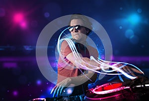 Disc jockey playing music with electro light effects and lights