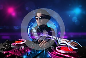 Disc jockey playing music with electro light effects and lights