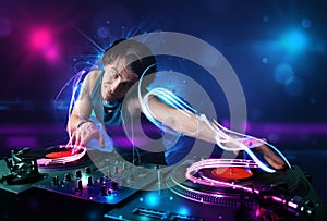 Disc jockey playing music with electro light effects and lights