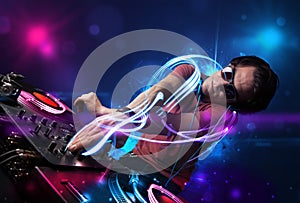 Disc jockey playing music with electro light effects and lights