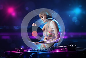 Disc jockey playing music with electro light effects and lights