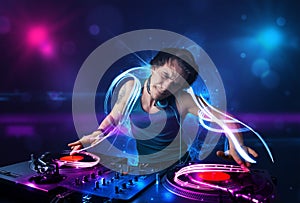 disc jockey playing music with electro light effects and lights