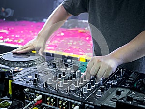 Disc Jokey Hands on a sound mixer station
